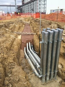 A photo of pipes and underground wiring.