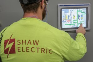 A Shaw employee operates an agricultural system interface.
